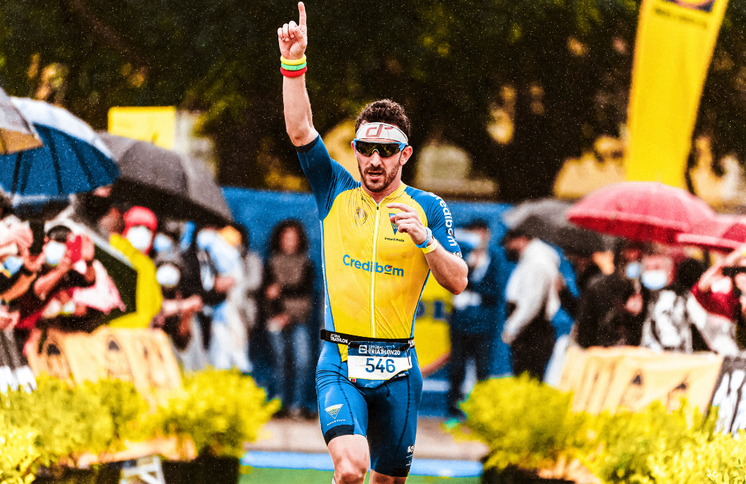 An athlete celebrating as he crosses the finish line at a sporting event.